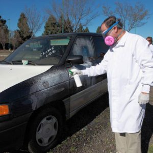 Man spraying car for fingerprints